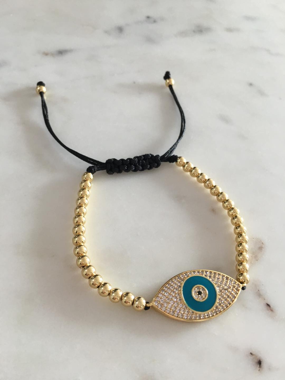 Harper gold bead evil eye charm